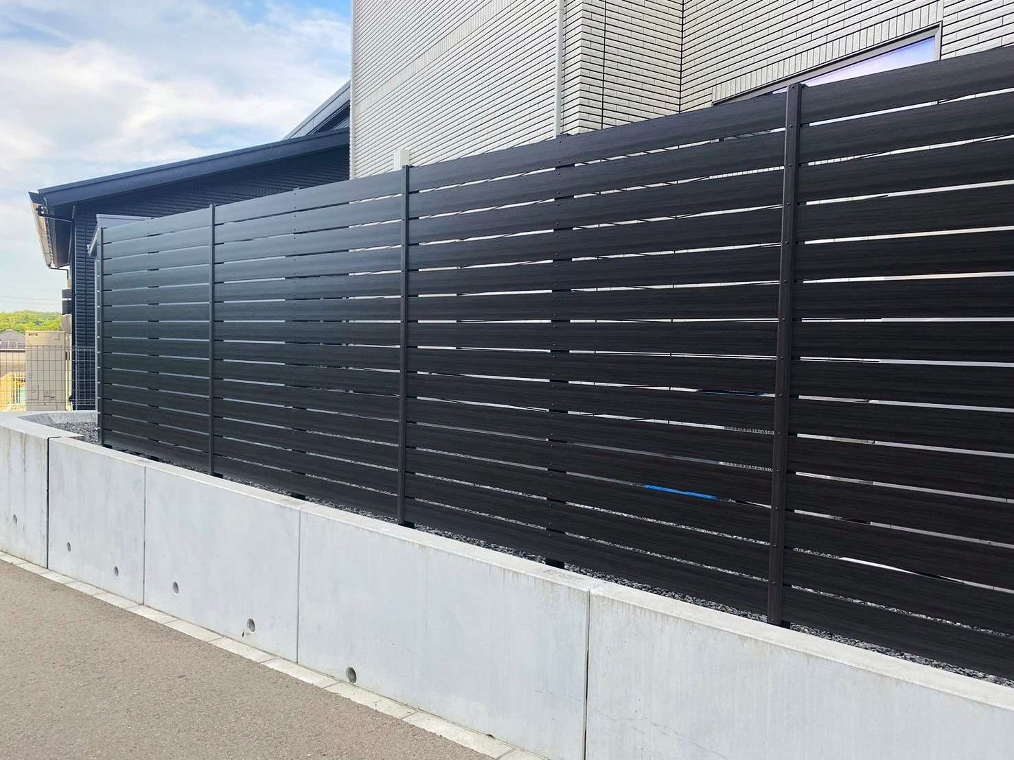 人工木材のダーク木調フェンス｜大分市